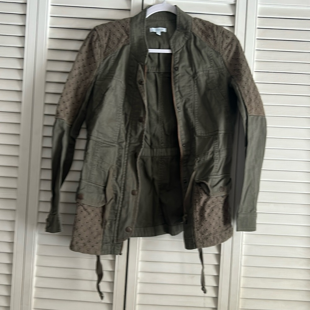 Jacket olive green size small zipper and snaps.  Draw string & pockets